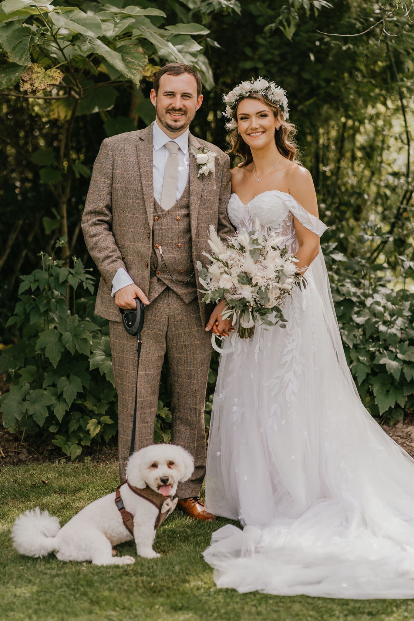 Bride and groom with their dog at a wedding